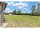 Expansive backyard with lush green grass, mature trees, and a view of the screened-in patio at 9658 Sw 76Th Lane Rd, Ocala, FL 34481