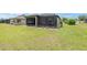 A spacious backyard with a screened lanai, offering a relaxing outdoor living space for comfortable leisure at 9658 Sw 76Th Lane Rd, Ocala, FL 34481