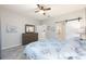 Comfortable bedroom showcasing a large dresser and a sliding barn door to the bathroom at 9658 Sw 76Th Lane Rd, Ocala, FL 34481