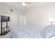 Bright bedroom with closet space, a ceiling fan, and a television on a stand next to a sunny window at 9658 Sw 76Th Lane Rd, Ocala, FL 34481