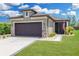 Charming single-story home featuring a two-car garage, manicured lawn, and beautiful landscaping at 9658 Sw 76Th Lane Rd, Ocala, FL 34481