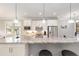 Open kitchen design with stainless appliances, white cabinetry, granite countertops, and pendant lighting at 9658 Sw 76Th Lane Rd, Ocala, FL 34481