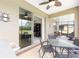 Covered patio with a grill, outdoor dining table, and comfortable seating areas for relaxing and entertaining at 9658 Sw 76Th Lane Rd, Ocala, FL 34481