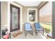 Inviting front porch with comfortable seating, decorative door, and a view of the yard at 9658 Sw 76Th Lane Rd, Ocala, FL 34481