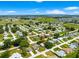 Expansive aerial view of a neighborhood showcasing well-maintained homes and lush greenery under a bright blue sky at 10016 Sw 62Nd Cir, Ocala, FL 34476