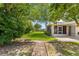 View of the beautifully landscaped backyard with mature trees and lush lawn at 10016 Sw 62Nd Cir, Ocala, FL 34476