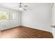 Well-lit bedroom with wood floors, ceiling fan, and natural light at 10016 Sw 62Nd Cir, Ocala, FL 34476