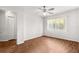 Bright bedroom features a ceiling fan, wood-look flooring, and a large window at 10016 Sw 62Nd Cir, Ocala, FL 34476