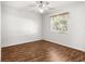 Bedroom with a ceiling fan, neutral walls, and a large window with shade at 10016 Sw 62Nd Cir, Ocala, FL 34476