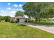 Inviting single-story home with an attached garage, lush landscaping, mature trees, and a well-maintained lawn for great curb appeal at 10016 Sw 62Nd Cir, Ocala, FL 34476