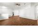 Spacious open-plan living room with hardwood floors, ceiling fan, and white walls at 10016 Sw 62Nd Cir, Ocala, FL 34476