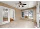 Light-filled sunroom with tile floor, ceiling fan, and windows overlooking the yard at 10016 Sw 62Nd Cir, Ocala, FL 34476