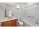 Bathroom featuring a modern single sink vanity, toilet, and a shower-tub combo with grab bars at 10277 Sw 96Th Loop, Ocala, FL 34481