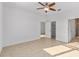 Comfortable bedroom featuring tile floors, ceiling fan, and ensuite bathroom at 10277 Sw 96Th Loop, Ocala, FL 34481