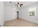 Well-lit bedroom with neutral paint, ceiling fan, closet and tiled floor at 10277 Sw 96Th Loop, Ocala, FL 34481