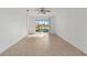 Spacious room with tile flooring, a ceiling fan, and a sliding glass door at 10277 Sw 96Th Loop, Ocala, FL 34481