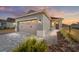 Inviting single-Gathering home featuring a two-car garage and well-maintained landscaping at sunset at 10277 Sw 96Th Loop, Ocala, FL 34481