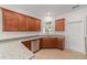 Kitchen with ample counterspace, wood cabinets, stainless steel dishwasher and tile floors at 10277 Sw 96Th Loop, Ocala, FL 34481