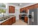 Kitchen with granite counters, stainless steel microwave and oven, and tiled floors at 10277 Sw 96Th Loop, Ocala, FL 34481