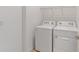 Laundry room area with full-size white washer and dryer at 10277 Sw 96Th Loop, Ocala, FL 34481