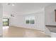 Bright living room boasts tile flooring and sliding glass doors for seamless indoor-outdoor living at 10277 Sw 96Th Loop, Ocala, FL 34481