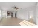 Open-concept living room featuring neutral tile floors and a ceiling fan at 10277 Sw 96Th Loop, Ocala, FL 34481