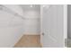 Spacious walk-in closet with wire shelving for optimal organization and tiled floor at 10277 Sw 96Th Loop, Ocala, FL 34481