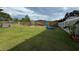 Expansive backyard with lush green grass, fencing, and ample space for outdoor activities at 1100 Nw 126Th Ln, Citra, FL 32113