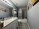 Well-maintained bathroom with tiled floors, a single sink vanity, and a shower-tub combo at 1100 Nw 126Th Ln, Citra, FL 32113
