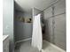 Updated bathroom featuring a shower with stylish tiling and a shower curtain at 1100 Nw 126Th Ln, Citra, FL 32113