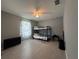 Simple bedroom featuring a bunk bed, ceiling fan, and light-colored floors at 1100 Nw 126Th Ln, Citra, FL 32113