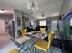 Inviting dining area with yellow chairs, a modern table, and a view of the living space at 1100 Nw 126Th Ln, Citra, FL 32113