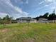 Charming single-story home featuring a spacious yard with mature trees, green lawn and fencing at 1100 Nw 126Th Ln, Citra, FL 32113