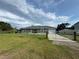 Beautiful single-story home with a fenced yard, green lawn, and a concrete driveway at 1100 Nw 126Th Ln, Citra, FL 32113