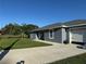 Charming single-story home with a well-maintained lawn and long concrete driveway at 1100 Nw 126Th Ln, Citra, FL 32113