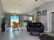 Open-concept living space with tile floors, comfortable seating, and dining area at 1100 Nw 126Th Ln, Citra, FL 32113
