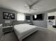 Comfortable main bedroom showcasing a ceiling fan, neutral walls, and sleek furniture at 1100 Nw 126Th Ln, Citra, FL 32113