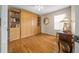 Bedroom featuring hardwood floors, a cabinet, and a side table with lamp at 11147 Sw 53Rd Cir, Ocala, FL 34476