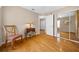Cozy bedroom with hardwood floors, chair, side table and a mirrored closet at 11147 Sw 53Rd Cir, Ocala, FL 34476