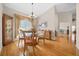 Bright dining room with hardwood floors, a glass table, and elegant chandelier at 11147 Sw 53Rd Cir, Ocala, FL 34476