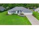 Well maintained home with beautiful landscaping, lush green lawn, and a neutral color scheme at 11147 Sw 53Rd Cir, Ocala, FL 34476