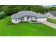 Well maintained home with beautiful landscaping, lush green lawn, and a neutral color scheme at 11147 Sw 53Rd Cir, Ocala, FL 34476