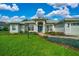 Attractive single-story home with a well-manicured lawn, colorful landscaping, and a two-car garage at 11147 Sw 53Rd Cir, Ocala, FL 34476