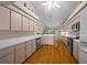 Spacious kitchen with light wood cabinets, white countertops, and hardwood floors at 11147 Sw 53Rd Cir, Ocala, FL 34476