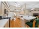 Open kitchen featuring wood floors, an eat-in bar, a ceiling fan, and ample counter space at 11147 Sw 53Rd Cir, Ocala, FL 34476