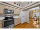 Well-equipped kitchen with stainless steel appliances, light wood cabinets, and hardwood floors at 11147 Sw 53Rd Cir, Ocala, FL 34476
