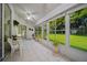 Enclosed lanai with tile floors, bright natural light, and views of the lush backyard at 11147 Sw 53Rd Cir, Ocala, FL 34476