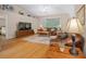 Inviting living room with hardwood floors, comfortable leather seating, and a large TV at 11147 Sw 53Rd Cir, Ocala, FL 34476