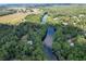 Aerial view of a riverfront community surrounded by lush trees and greenery at 11170 Sw 190Th Ave, Dunnellon, FL 34432
