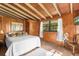 Warm bedroom with wood paneled walls, cozy decor and natural light at 11170 Sw 190Th Ave, Dunnellon, FL 34432